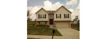 A two-story house with a garage and a driveway.
