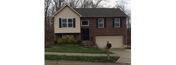 A house with a black door and a garage door.