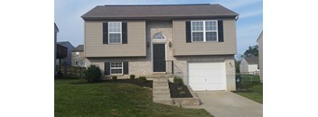 A house with a black front door and a white garage door.