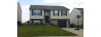 A house with a grey roof and a blue door.
