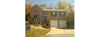 A house with a sign in front that says "lease option rent".