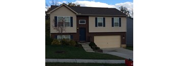 A house with a blue door and a garage door.