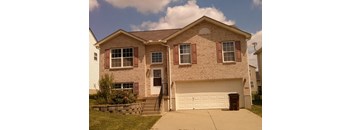 A two-story house with a white garage door and red shutters.