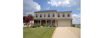 A two-story house with a garage on the right side.