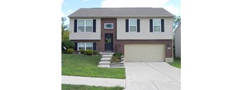 A house with a black front door and a garage door.