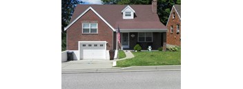 A red brick house with a white garage door.