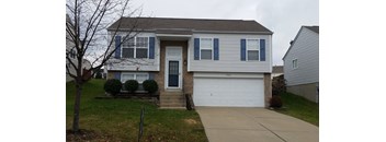 A two-story house with a white garage door.