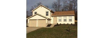 A two-story house with a garage on the left side.