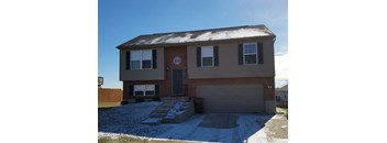 a brick house with snow on the ground