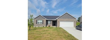 A house with a grey roof and a white garage door.