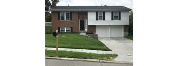 A brick house with a white garage door.