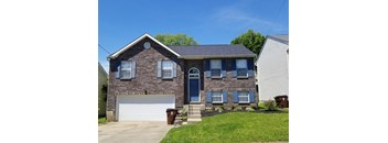 A two-story house with a garage and a blue door.