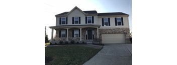 A house with a grey roof and a garage door.