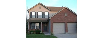A two-story house with a garage door.