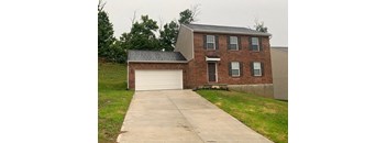 A brick house with a white garage door.