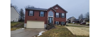 A red brick house with a white garage door.