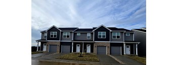 A row of houses with garages in front.
