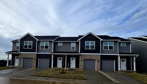 A row of houses with garages in front.