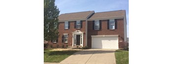 A brick house with a white garage door.