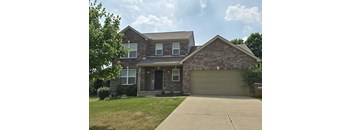 a house with a driveway and a garage door