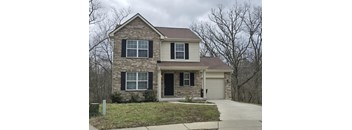 A two-story house with a garage on the side.