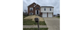 A brick house with a mailbox in front.