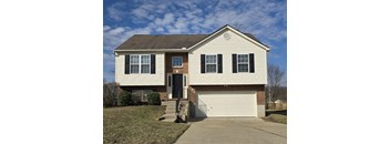A two-story house with a white garage door.