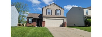a house with a garage door in front of it