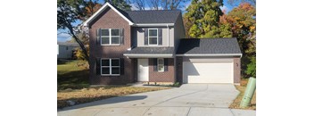 a red brick house with a white garage door