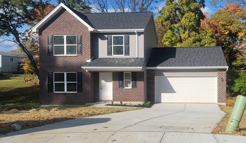 a red brick house with a white garage door