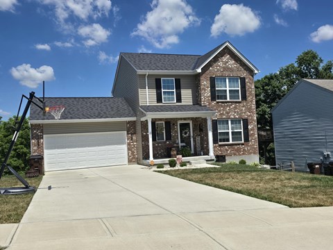 a house with a basketball hoop on the driveway