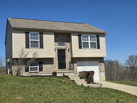 A two-story house with a garage on the right side.