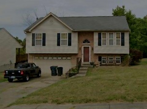 A house with a car parked in front.