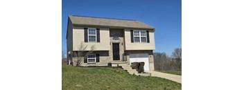 A two-story house with a garage on the right side.