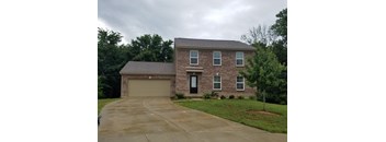 A house with a grey roof and a black door.