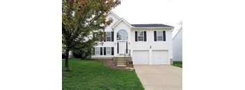 a white house with a garage and a driveway