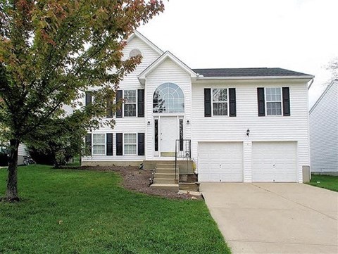 a white house with a garage and a driveway
