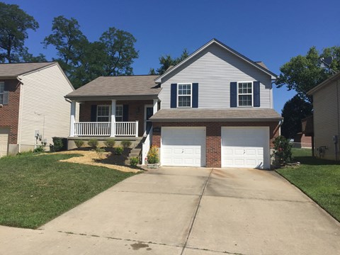 a white house with a driveway in front of it