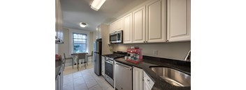 A kitchen with white cabinets and stainless steel appliances.