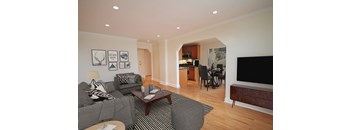 A living room with a grey couch and a coffee table.
