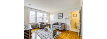 A living room with a grey couch and a coffee table.