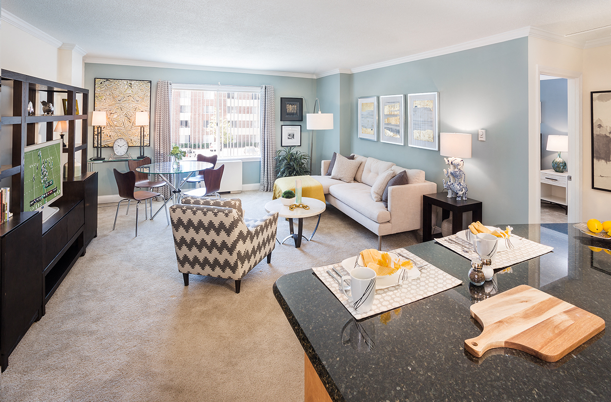 A living room with a black granite counter top and a white sofa.