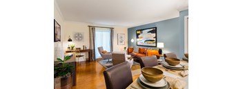 A living room with a brown chair and a table with bowls on it.
