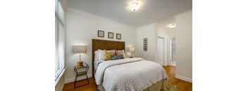 A bedroom with a large bed and a window.
