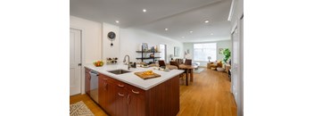 A kitchen with wooden cabinets and a white countertop.