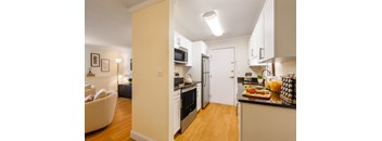A kitchen with a refrigerator, oven, and microwave.