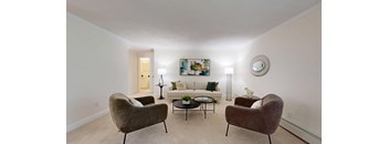 A living room with two chairs and a coffee table.