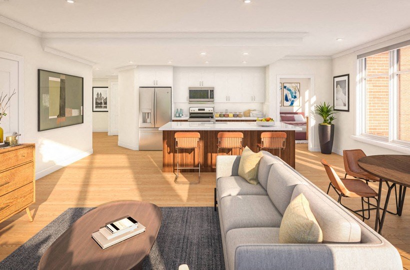 a living room with a couch and a kitchen