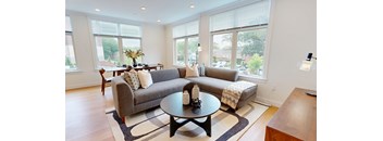 A living room with a grey couch and a coffee table.