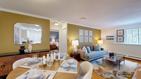 A dining room with a table set for a meal.